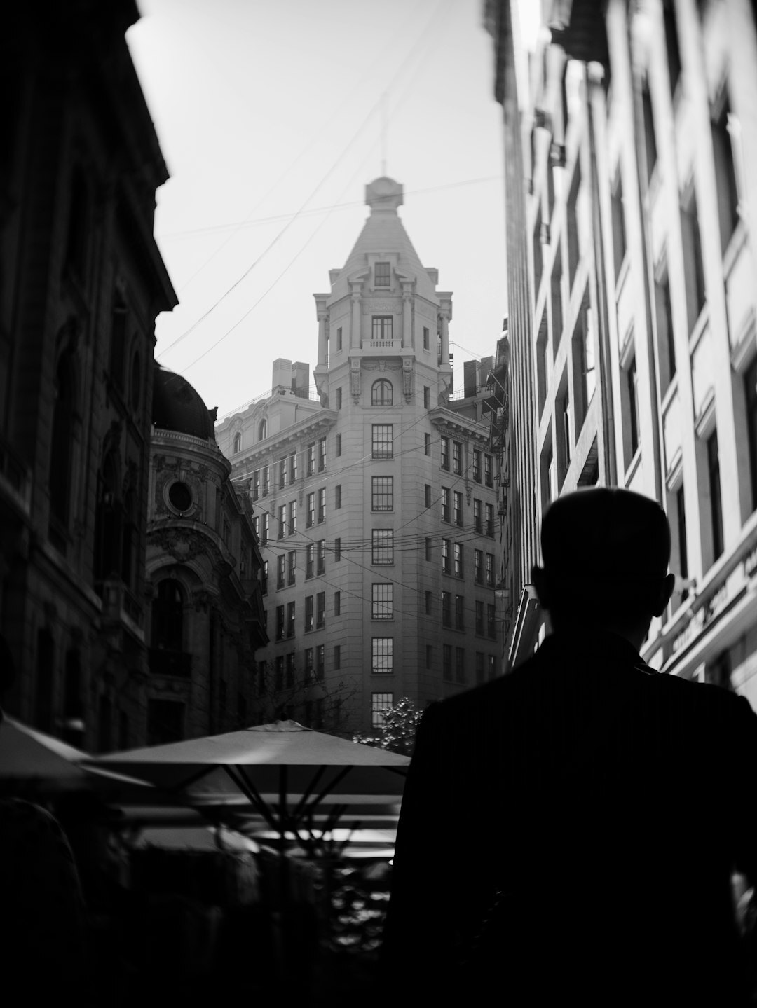 Portrait of a Chilean documentary photographer holding a camera on a Santiago street